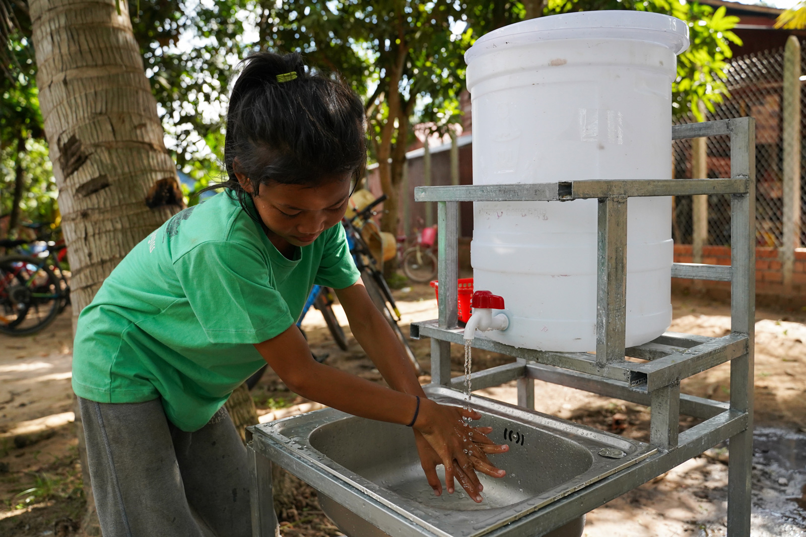 A donor gave a hand-washing station and volunteers taught students how to wash their hands properly at the Village Library in Areak Svay Village.