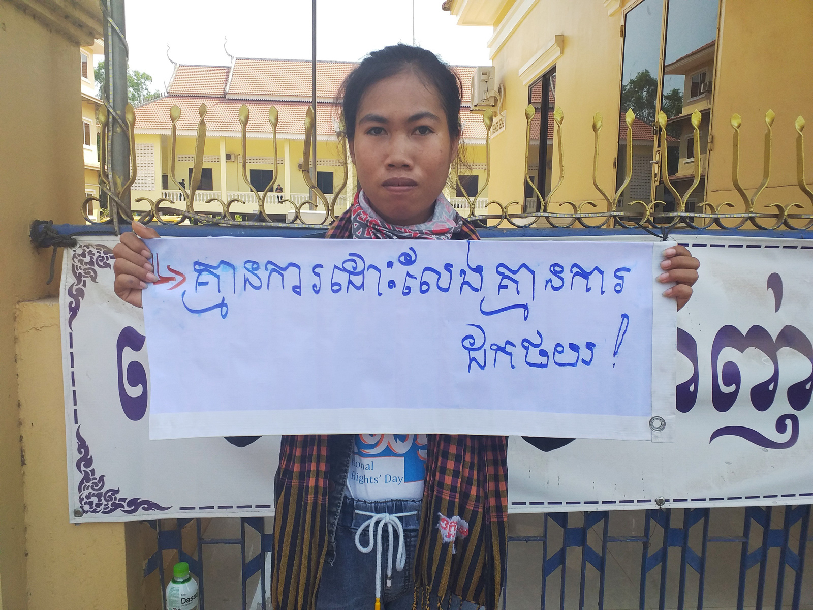 Mother Nature Cambodia activist Long Kunthea protests the arrest of environmental activist Ouch Leng in Stung Treng province in March 2020, holding a sign reading: “No release, no withdrawal.”