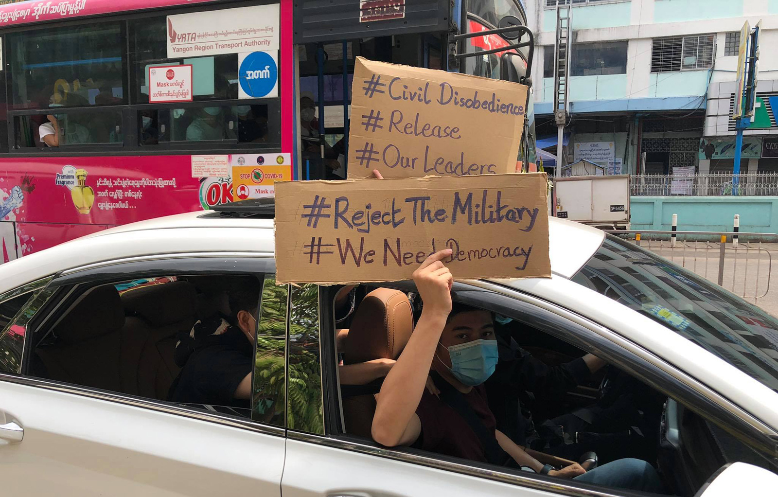 Protesters in Yangon hold signs denouncing Myanmar’s military coup in February 2021.